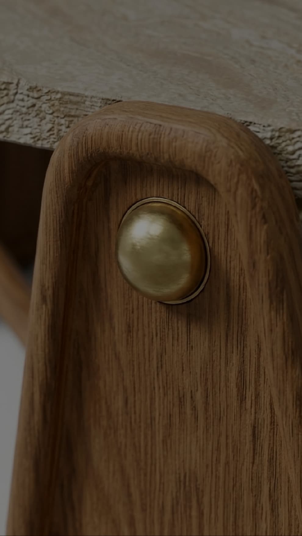 Nuvé — solid oak detail with polished brass stud