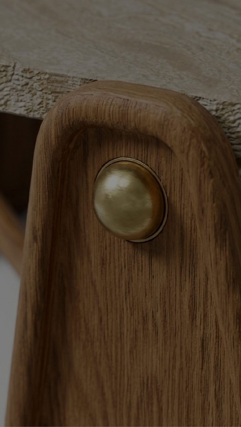 Nuvé — solid oak detail with polished brass stud
