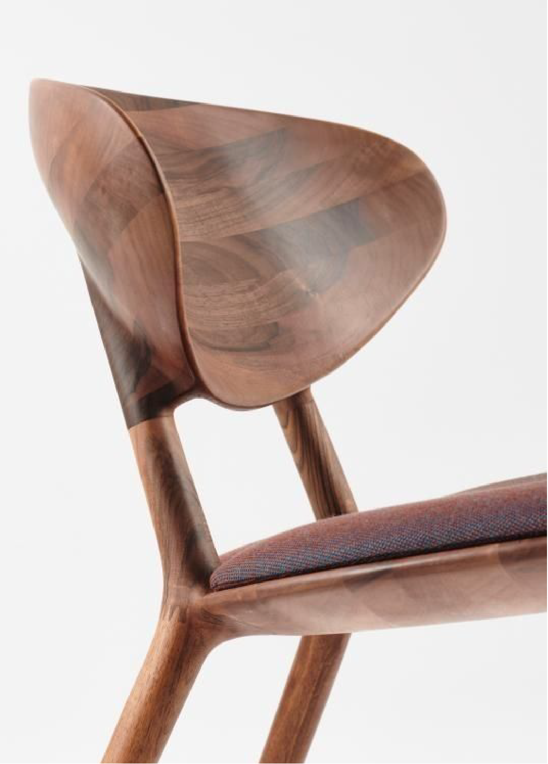 Sculpted walnut chair backrest, detail of curved joinery